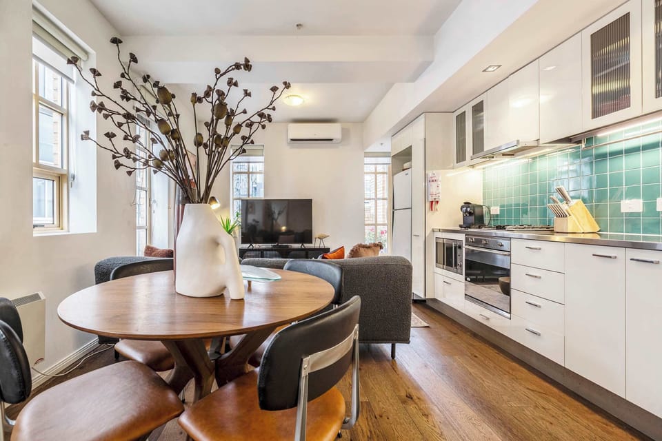 Dining and Kitchen at Tribeca: Bright open-plan dining and kitchen area with modern appliances and stylish details