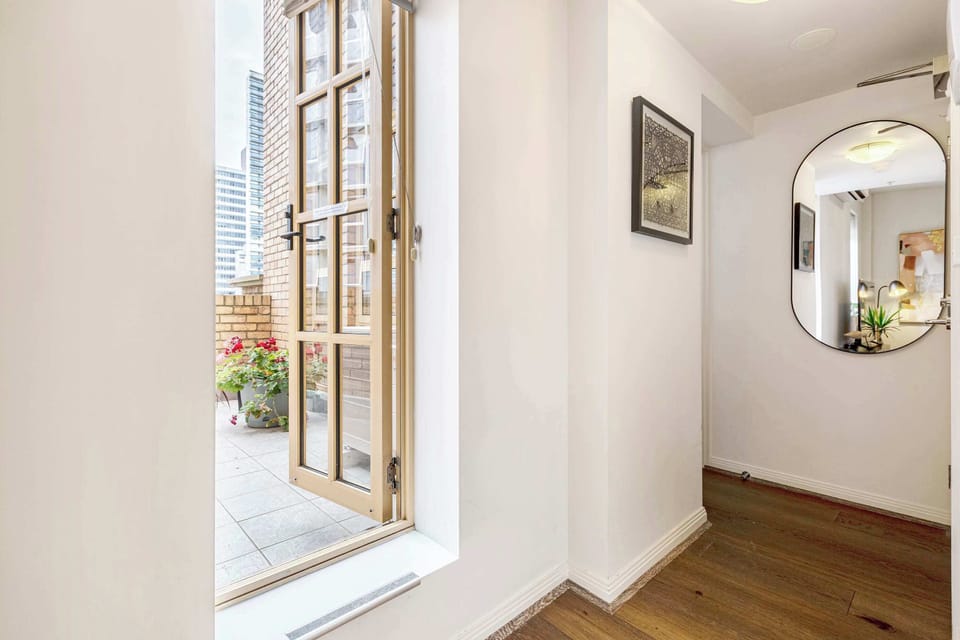 Common Space: Light filled entryway leading out to the private balcony