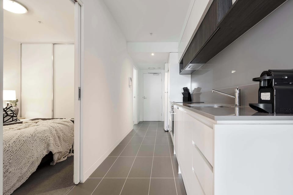 KITCHEN: Minimalist in design, complete in function. This fully equipped kitchen pairs clean lines with modern appliances and thoughtful details. Whether you're brewing a slow coffee or cooking something special, it’s ready when you are.