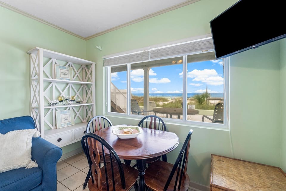 The living room area offers ample, comfortable seating and a dining table overlooking the gulf. (There is a Smart TV, but no cable or WiFi. Guests should bring a hot spot if they wish to use the Smart TV).