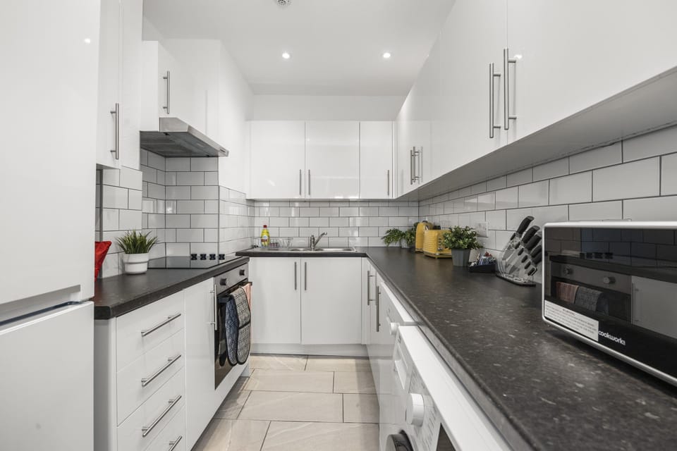 Fully equipped kitchen with modern appliances and ample counter space for meal preparation