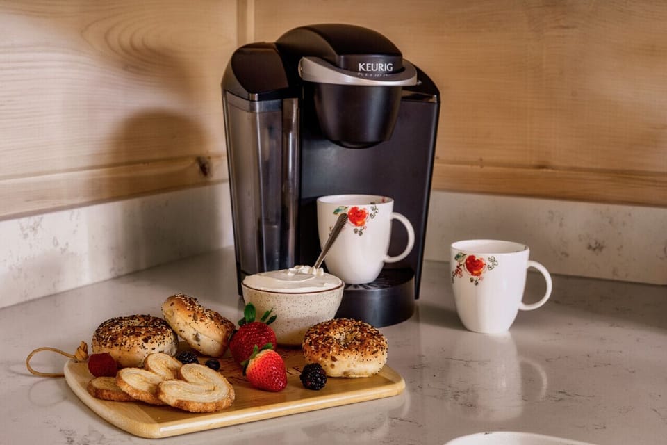 Start your day with fresh coffee and breakfast treats in a cozy kitchen setup!