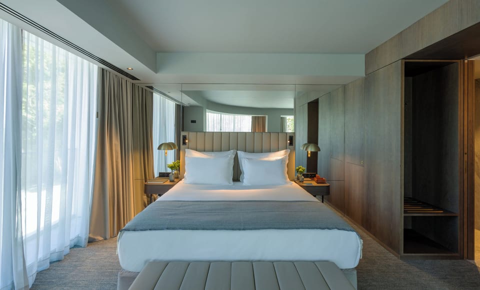 Suite, River View | Minibar, in-room safe, desk, laptop workspace