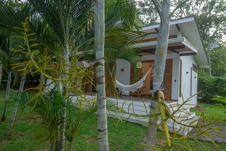 Tropical villa exterior surrounded by lush garden at Tres Lodge Resort in Playa Chiquita, Costa Rica
