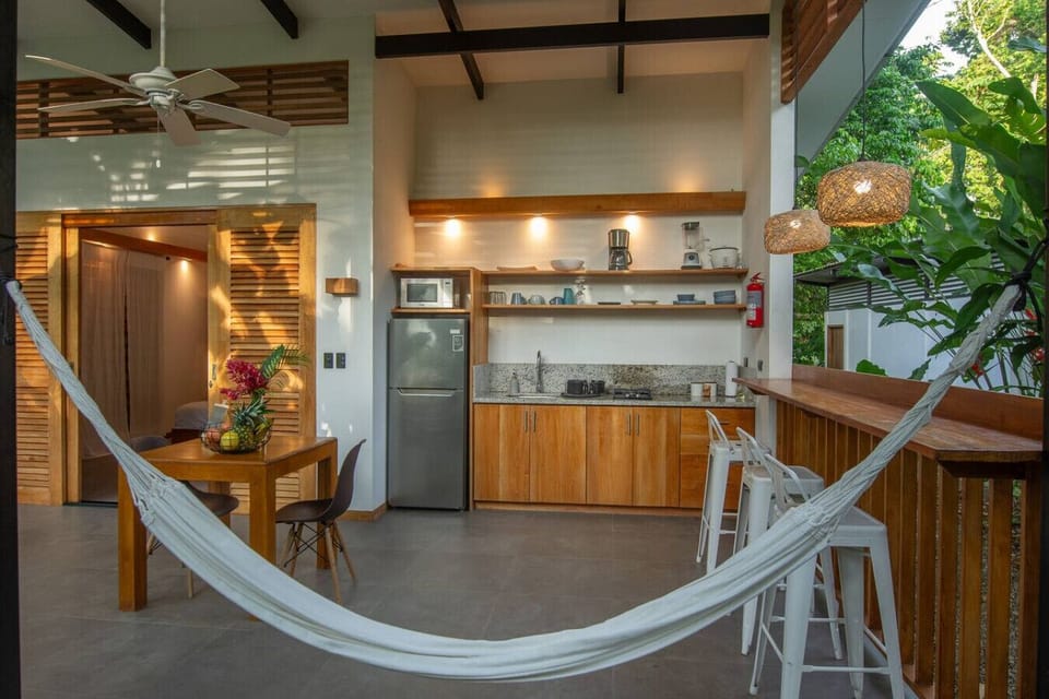 Open-air kitchen and hammock lounge at Tres Lodge Resort in Playa Chiquita, Costa Rica