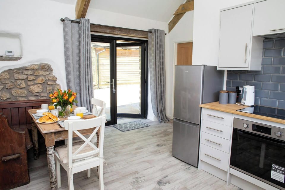 Kitchen/dining area with patio tables leading to the garden