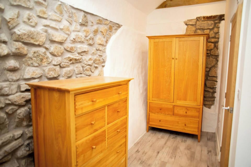 King size bedroom with chest of drawers and double wardrobe