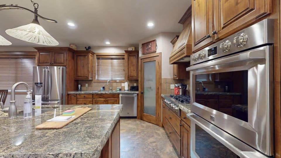 Equipped with stainless steel appliances, dishes, silverware, pots and pans, and basic cooking essentials.