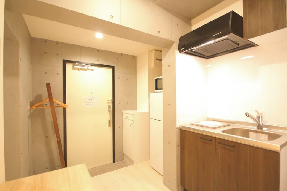 There are hangers and racks for hanging clothes right next to the entrance.