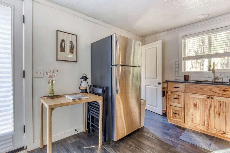 Love the cozy, clean vibe—natural wood and simple decor make it feel warm and inviting.