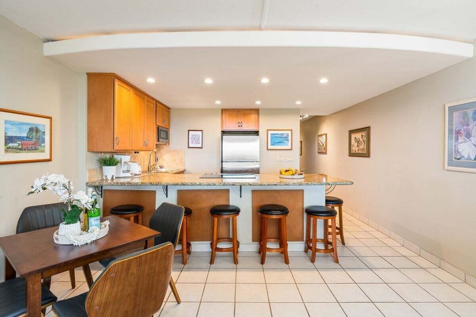 Indoor dining table for four with additional seating at countertop