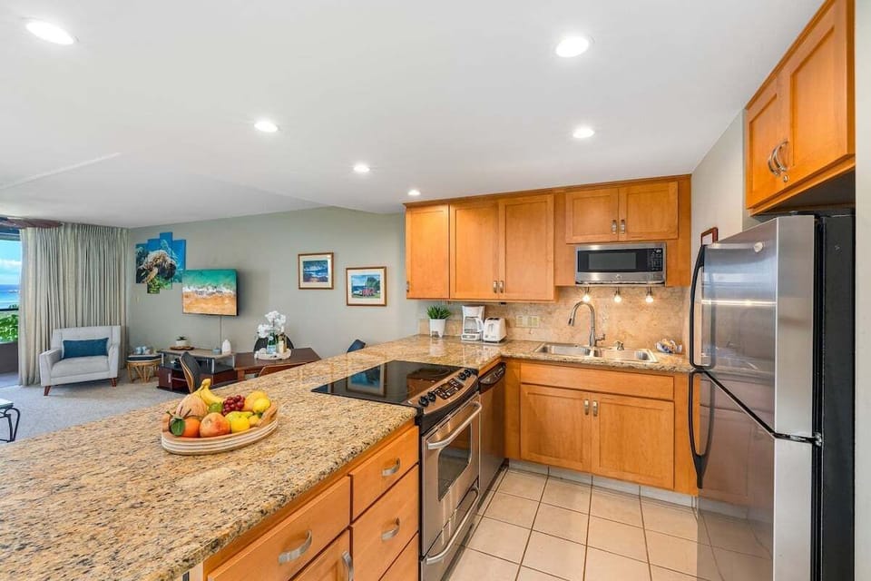 Updated kitchen highlighted by granite countertops with plenty of prep space