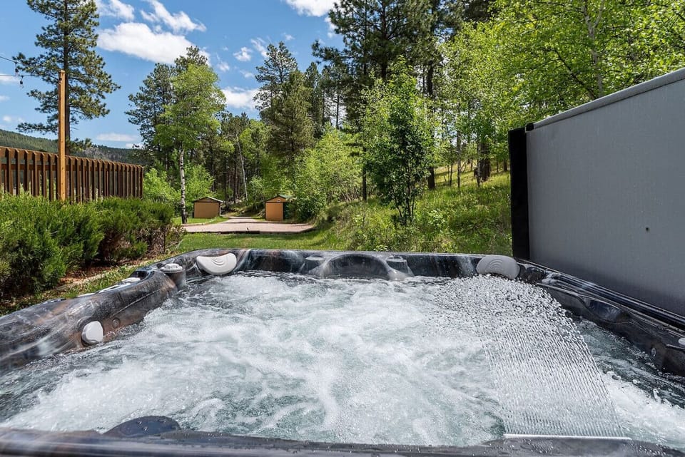 The hot tub is strategically placed in a secluded area, providing privacy and tranquility.