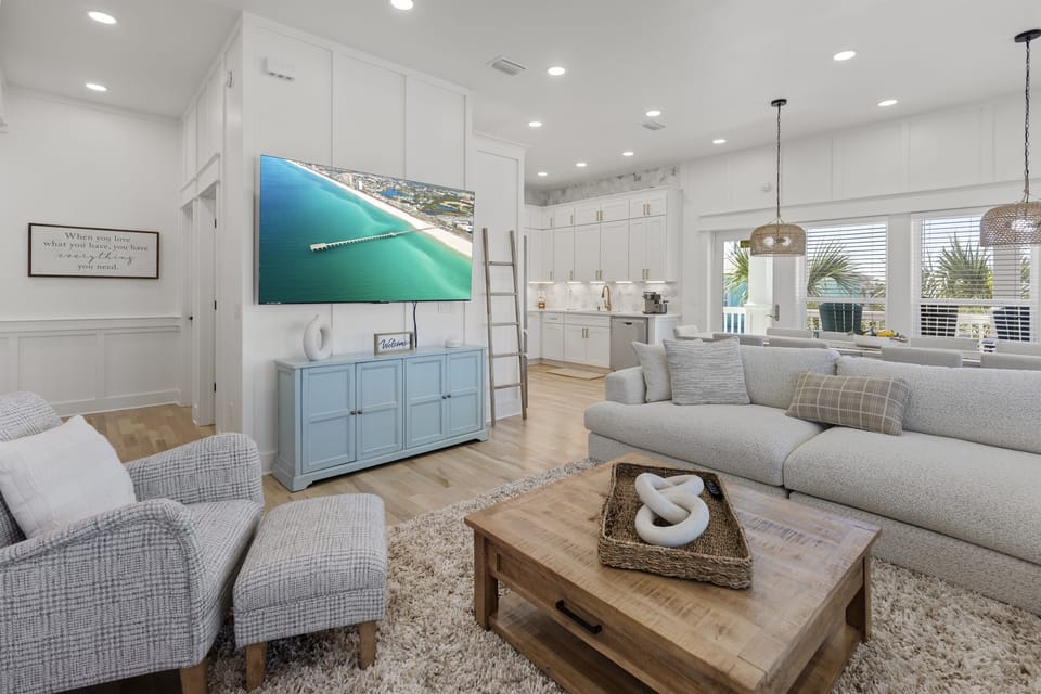 Unwind in your bright, coastal-inspired living space featuring plush seating and an open kitchen perfect for gathering with loved ones.