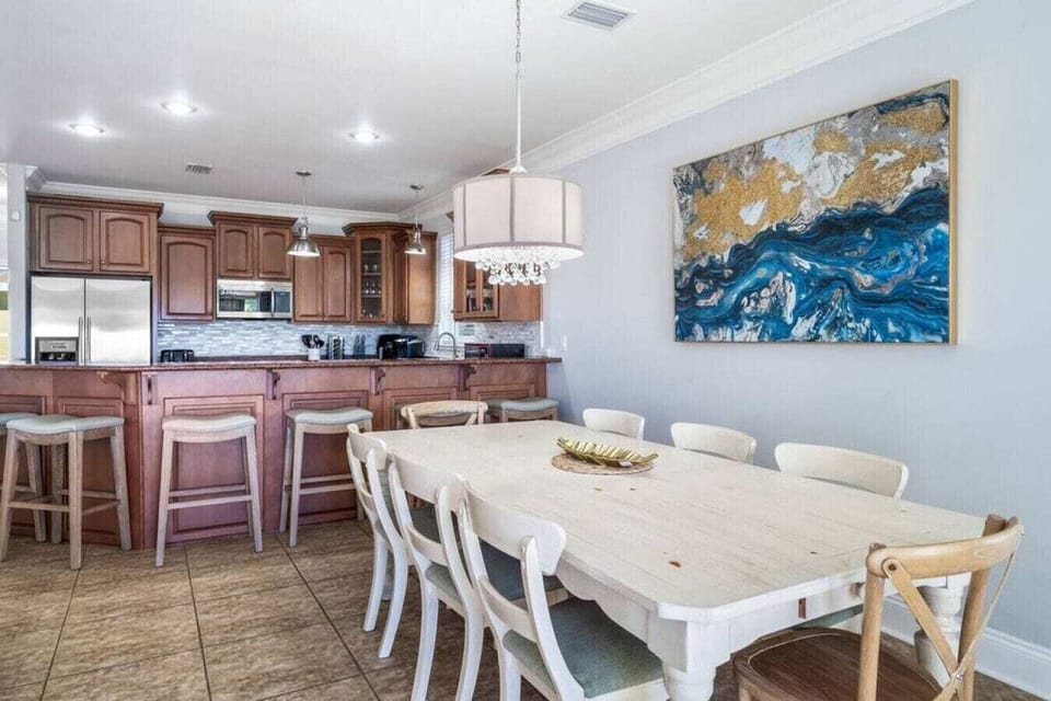 Your spacious open-plan dining area flows seamlessly into a fully-equipped kitchen, perfect for gathering and creating memorable meals together.