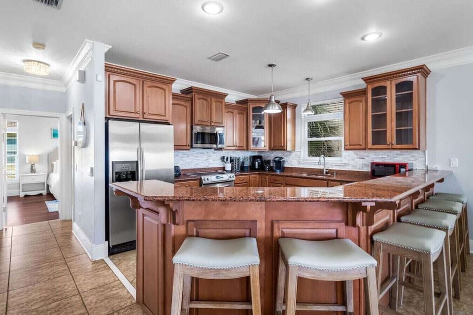 Your gourmet kitchen awaits with granite countertops, stainless steel appliances, and a spacious island for memorable meals together.
