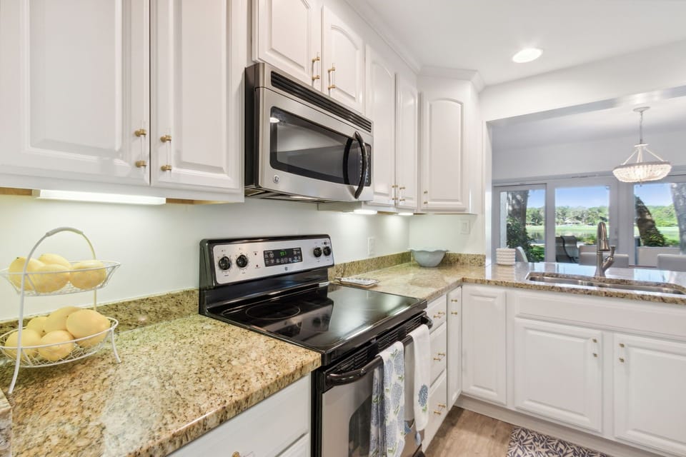 Updated Kitchen with Pristine White Cabinetry, Granite Countertops and Stainless Steel Appliances