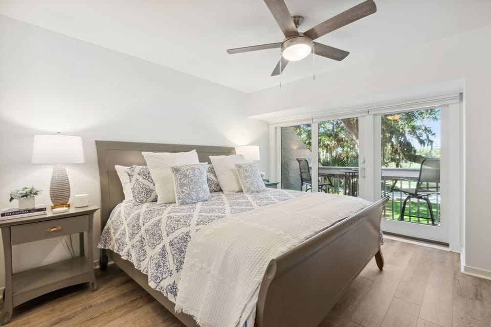 Unwind in the Master Bedroom Suite with Private Balcony, Gorgeous Golf Course and Lakeside Views, and a Flat Screen Smart TV (King Bed)