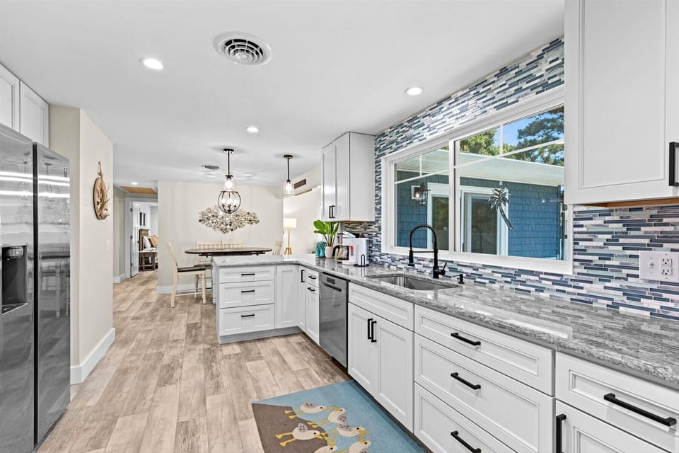 Stainless Appliances, stunning Countertops, and we adore that Backsplash!