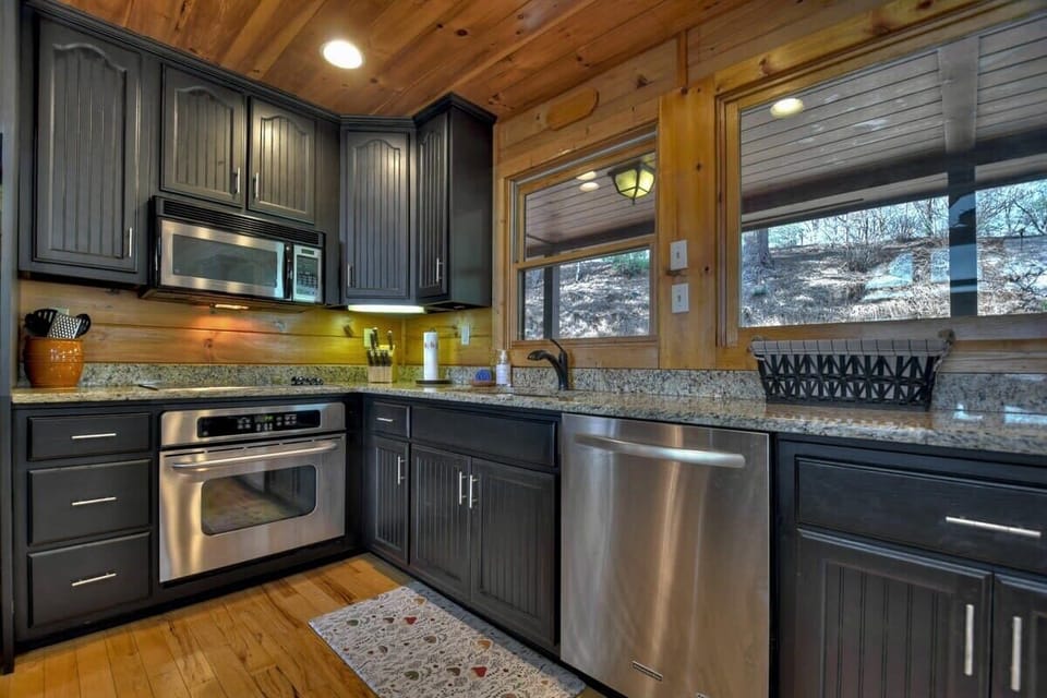 Fully equipped kitchen on the main level with open bar seating, perfect for entertaining and enjoying the beautiful views from the deck.