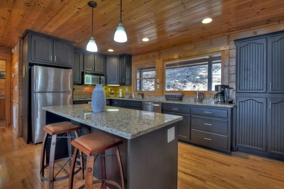 Fully equipped kitchen on the main level with open bar seating, perfect for entertaining and enjoying the beautiful views from the deck.