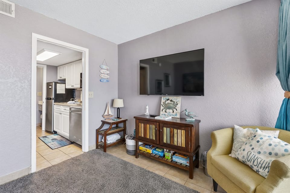 Relax in style with cozy decor and a sleek LED TV for the ultimate comfort and entertainment experience.