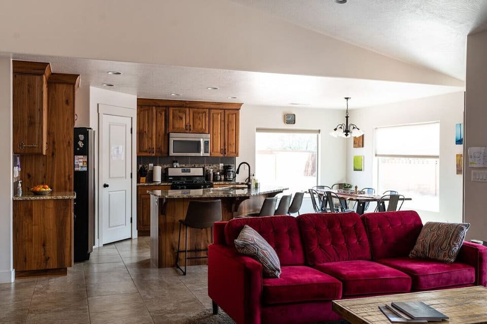 view of main room with kitchen, couch, and dining area. House is 1,400 square feet.