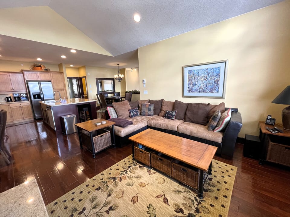 Large, cozy living room with propane fireplace and large smart TV with soundbar