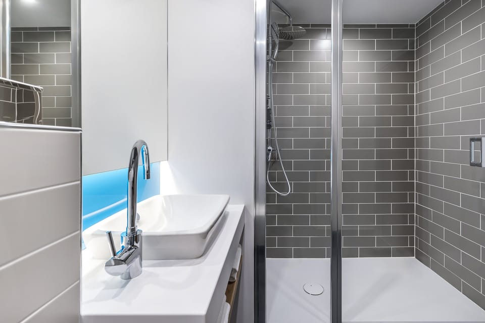 Shower, rainfall showerhead, hair dryer, towels