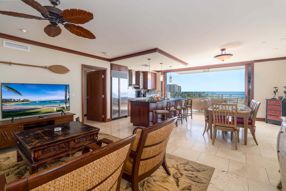 Open living room, dining room, and kitchen with ocean views.