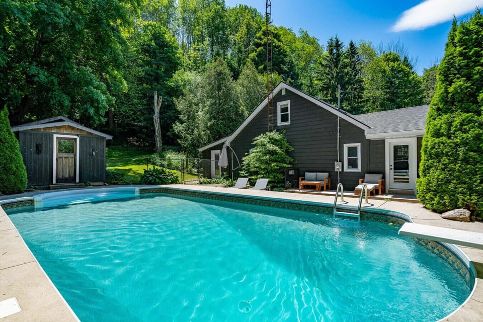 Soak up the sun by your private heated pool surrounded by forest, with lounge seating and a backyard art studio just steps away.