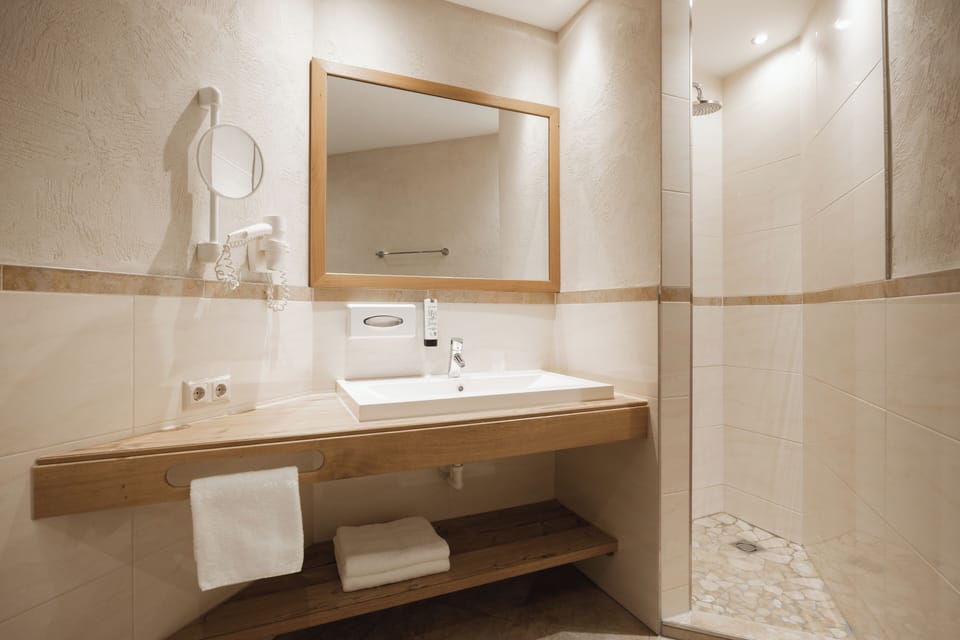 Junior Suite, Balcony, Mountain View | Bathroom | Hair dryer, bathrobes, towels