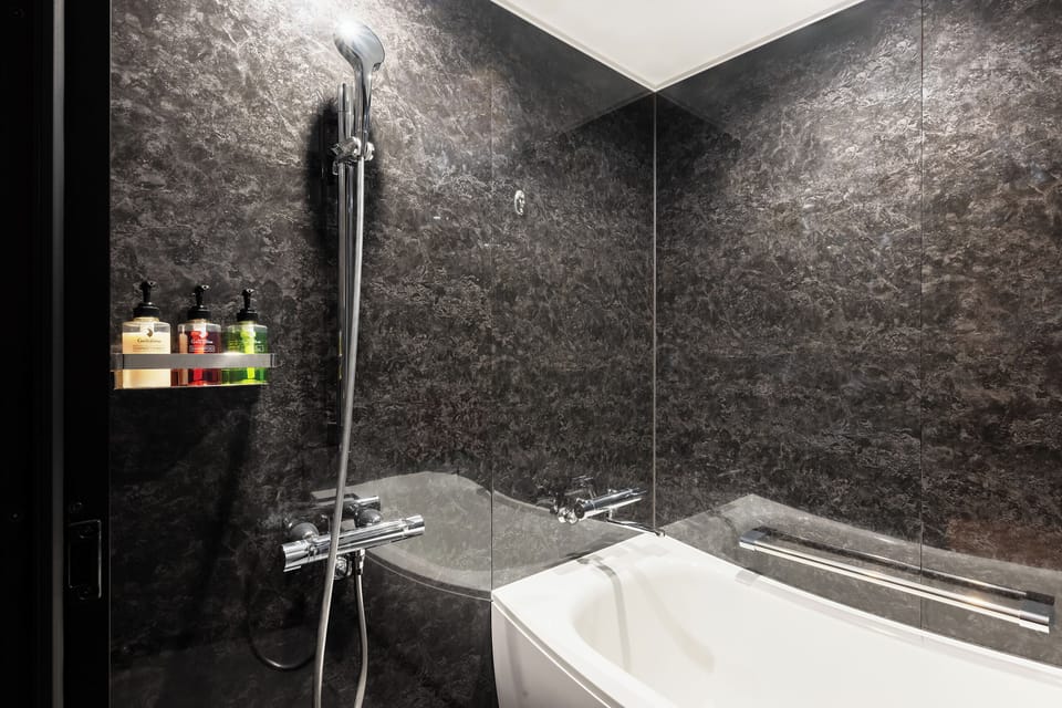 Separate tub and shower, free toiletries, hair dryer, slippers
