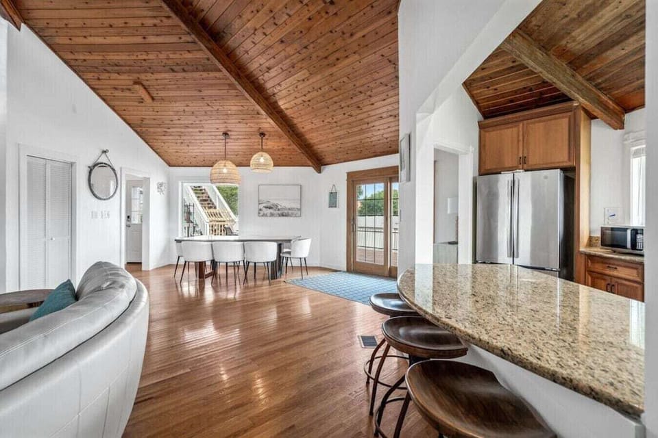 Your spacious open-concept retreat features soaring wood ceilings and gleaming hardwood floors, creating the perfect blend of rustic charm and modern comfort.