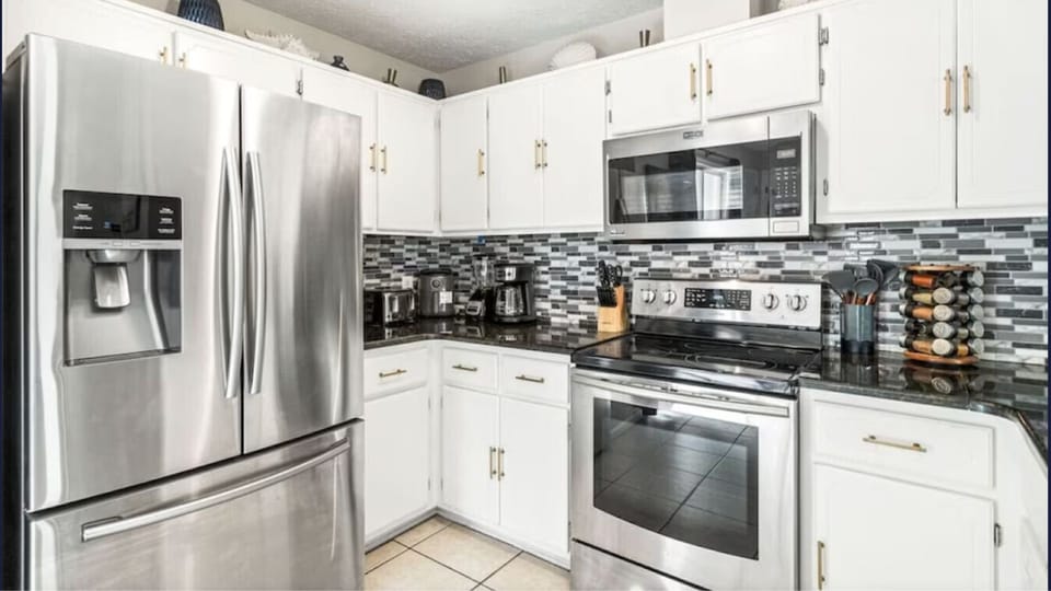 Step into your fully equipped kitchen with stainless steel appliances, stylish backsplash, and everything you need to create memorable meals during your stay.
