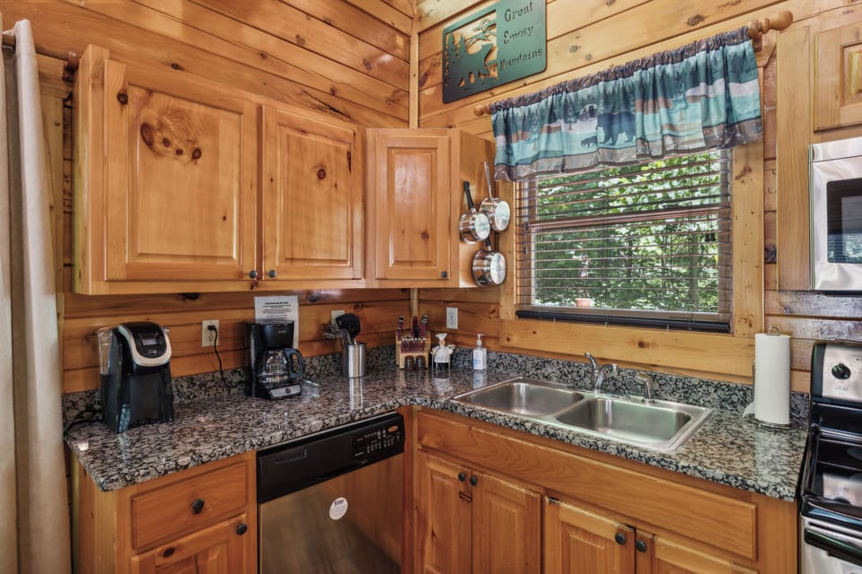 Kitchen area - wood cabinets and stainless appliances - plenty of prep space.