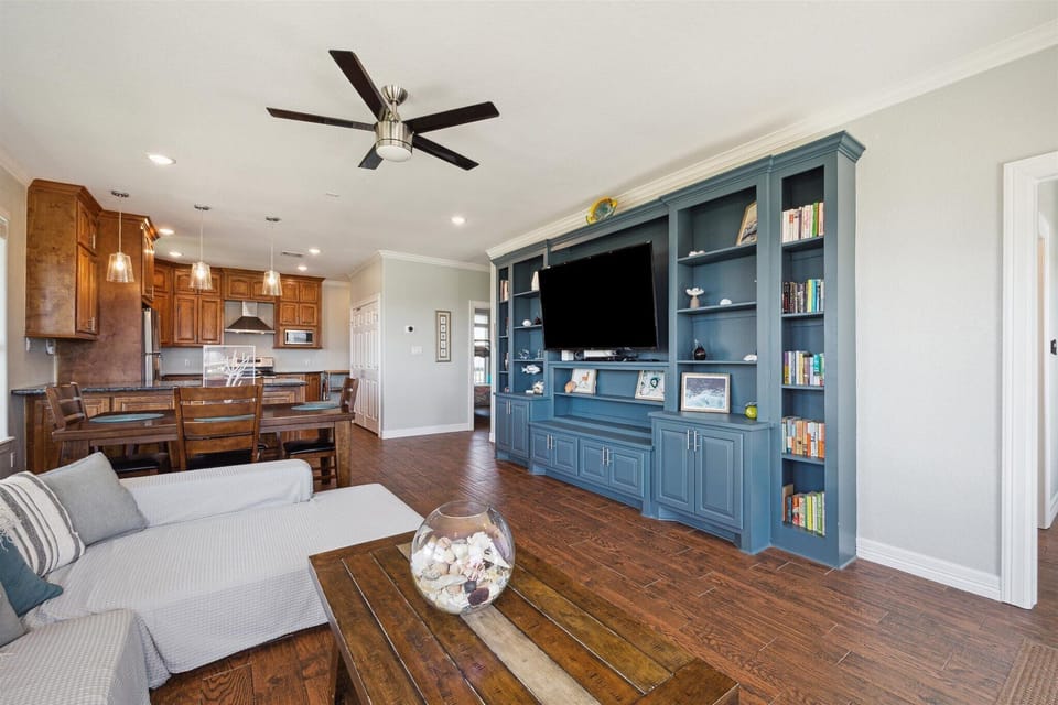 The open floor plan has a built-in cabinetry to provide ample space for guests in the living area.