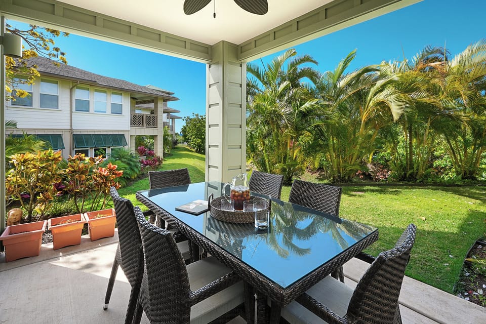Gather for a meal on the lanai, surrounded by tropical trees.