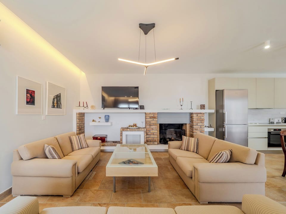 "Gather with loved ones in our elegantly designed living room, a space where comfort and style converge."