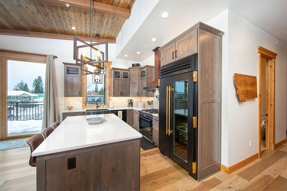 The kitchen island offers additional seating for three guests.