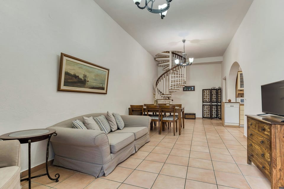 "Elegant and comfortable living room with a charming seating arrangement and warm ambiance."