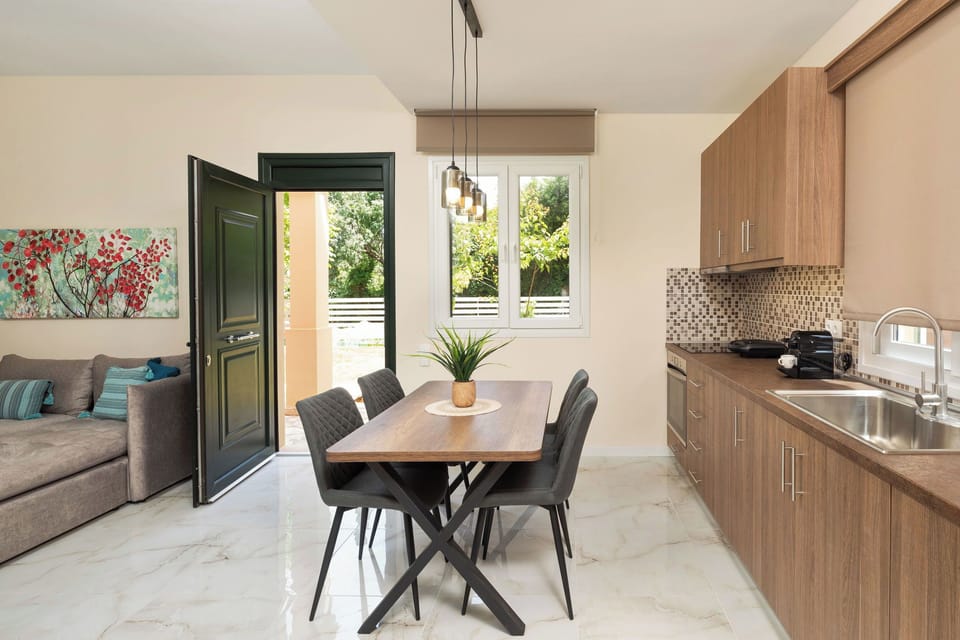 "The downstairs kitchen, with its modern amenities and dining table, is perfect for enjoying meals and quality time with loved ones."