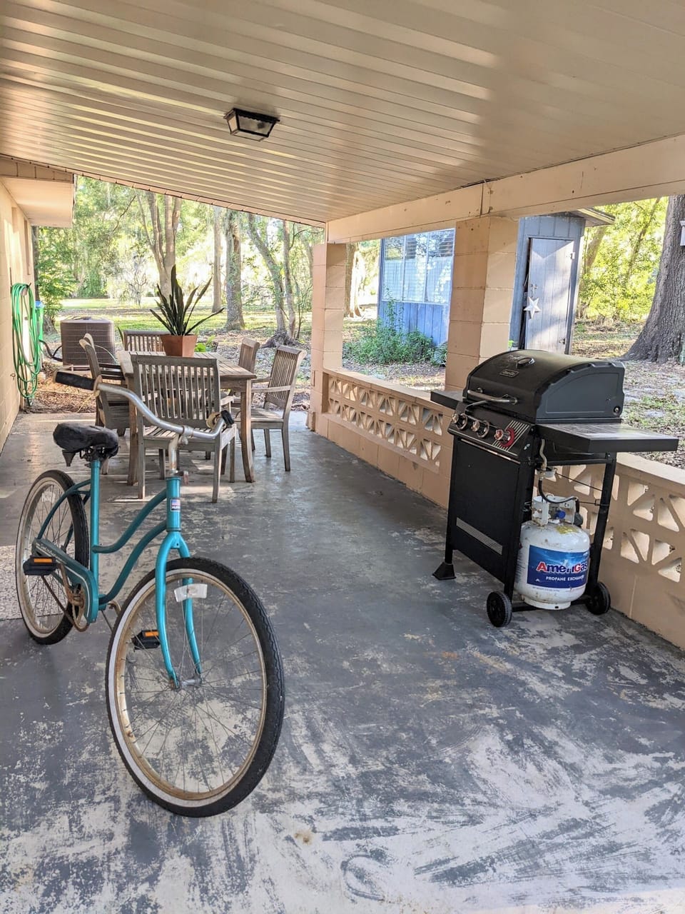 Carport with grill and outdoor eating area
