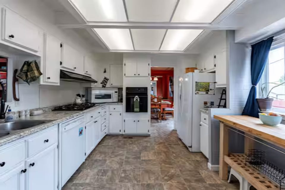 Enjoy easy meal prep in this fully equipped kitchen, featuring modern appliances and plenty of counter space.