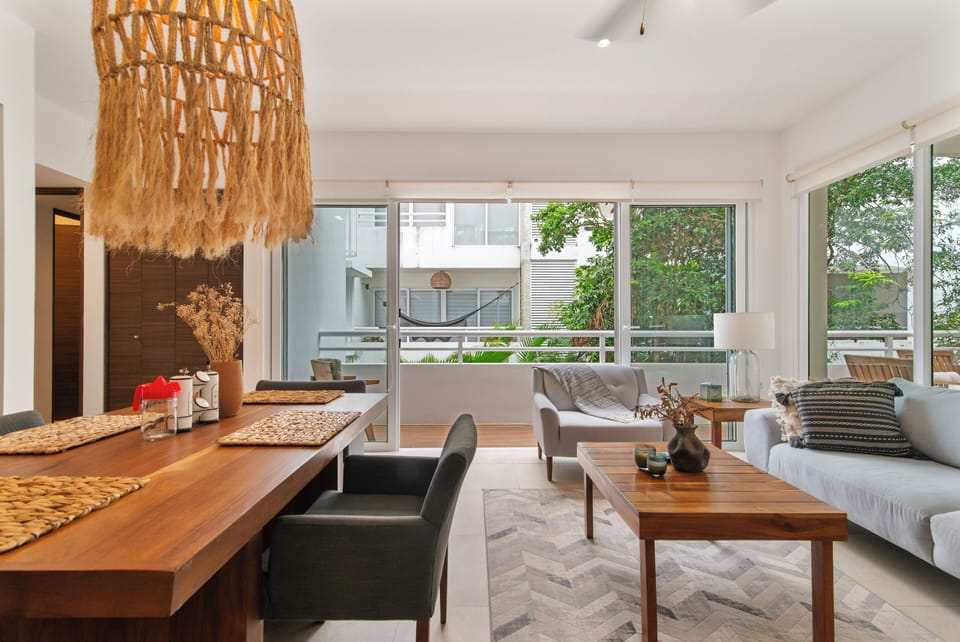 Relax in this cozy living room with balcony access, fresh air, and scenic views.