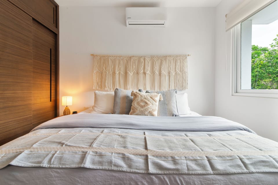Relax in this cozy bedroom with AC, ceiling fan, and darkening shades for comfort.