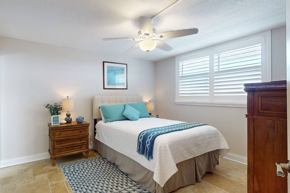 Second Bedroom: This cozy room is furnished with a queen-sided bed, and has private access to the second full bathroom