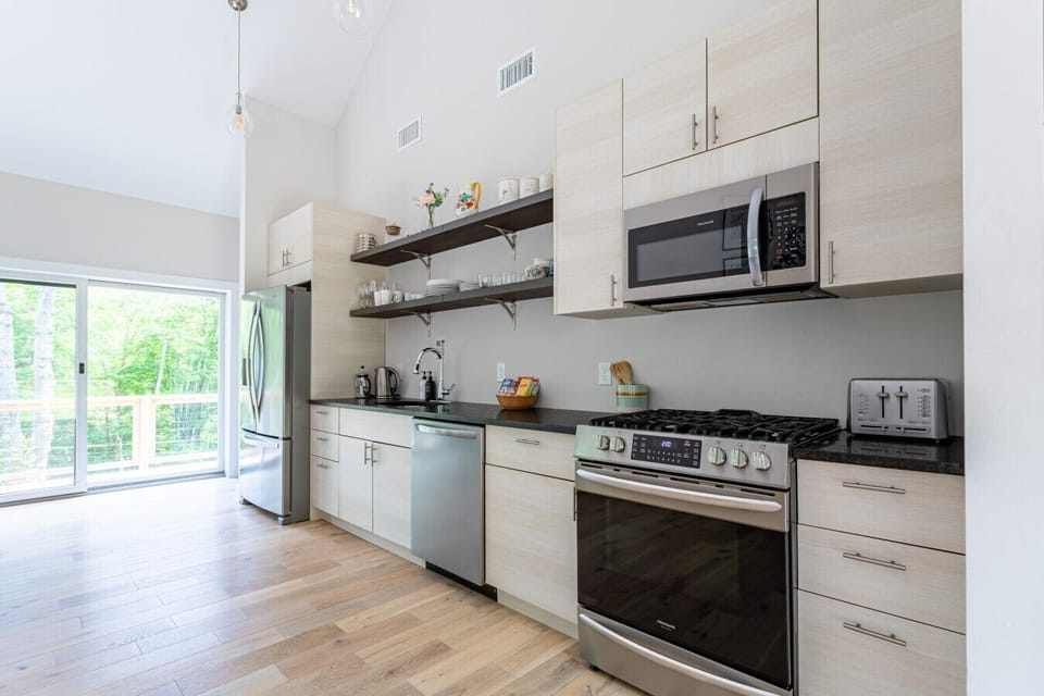 Modern, bright fully equipped kitchen with easy deck access