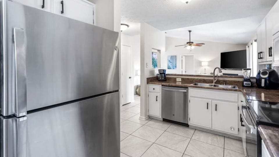 Your fully equipped kitchen awaits with stainless steel appliances, granite counters, and everything needed for home-cooked meals.