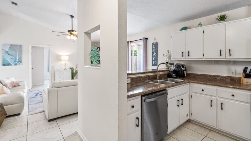 Your bright, open kitchen flows seamlessly into the living space, featuring granite counters and stainless appliances for easy meal prep.